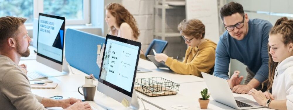 Developers and colleagues collaborating in a technology workspace